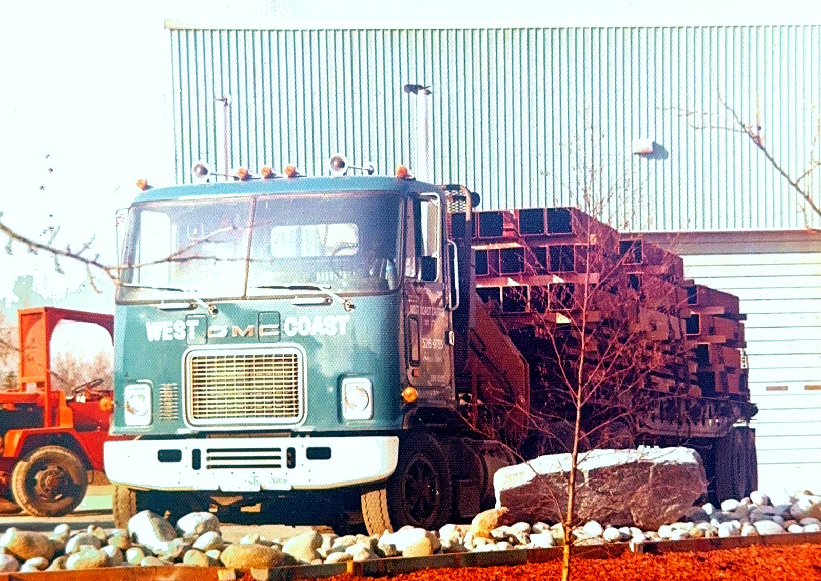 A West Coast Cartage GMC cab-over loaded with structural steel